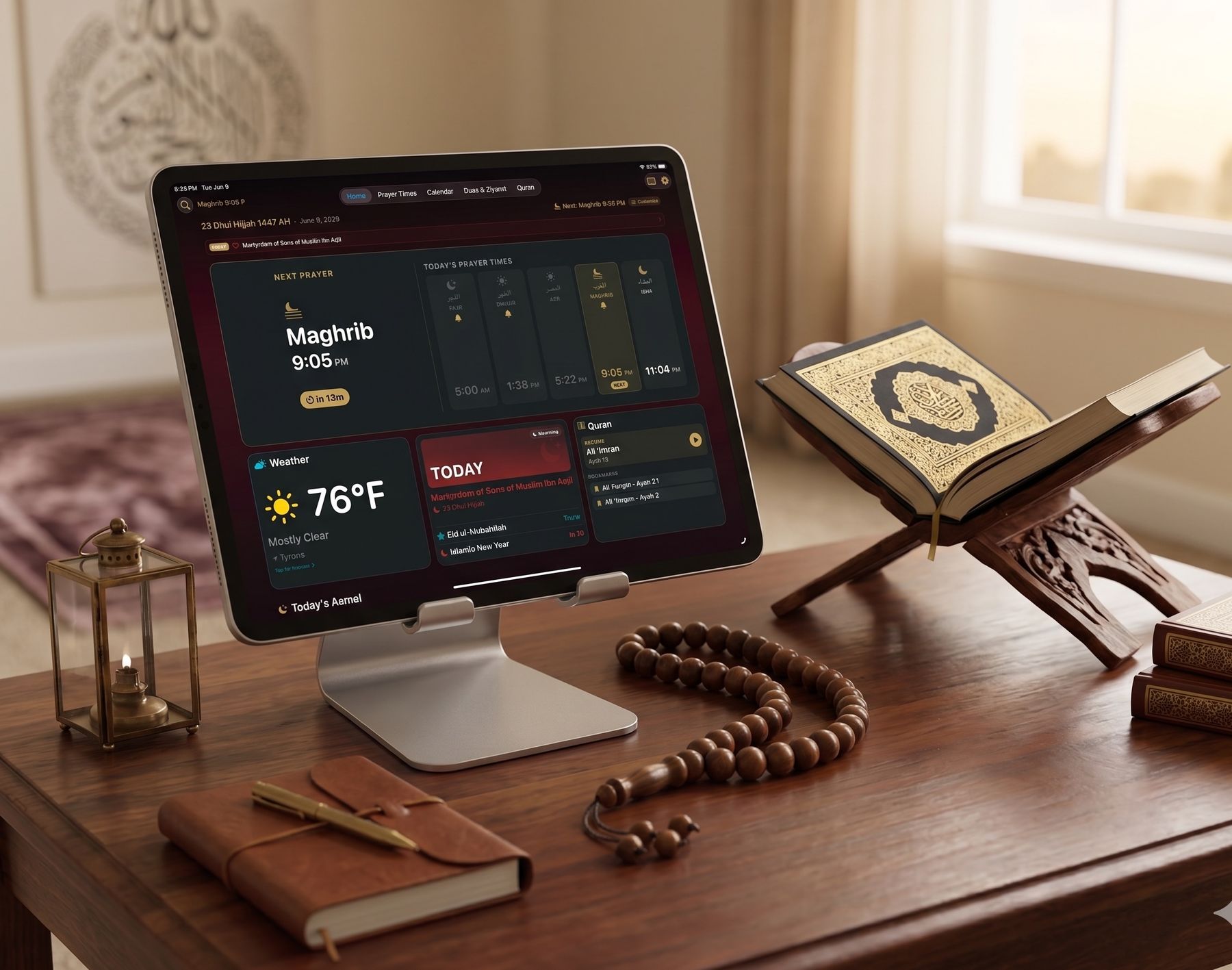 iPad on a silver stand on a wooden desk beside a Quran on a carved rehal and a tasbih, showing the Shia Daily home screen