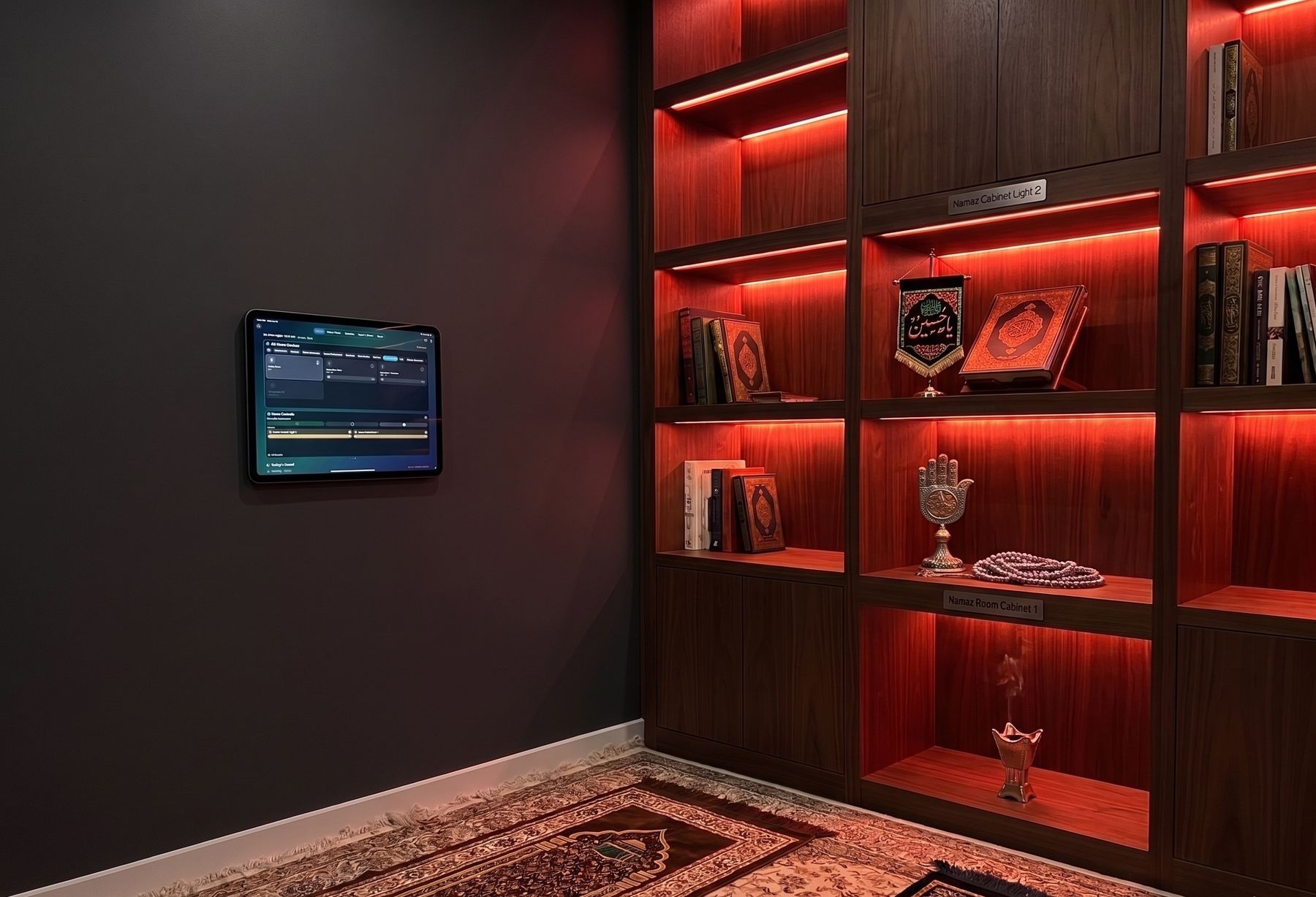 Wall-mounted iPad running Shia Daily HomeKit controls beside prayer room cabinets glowing with red shelf lighting for a night of mourning